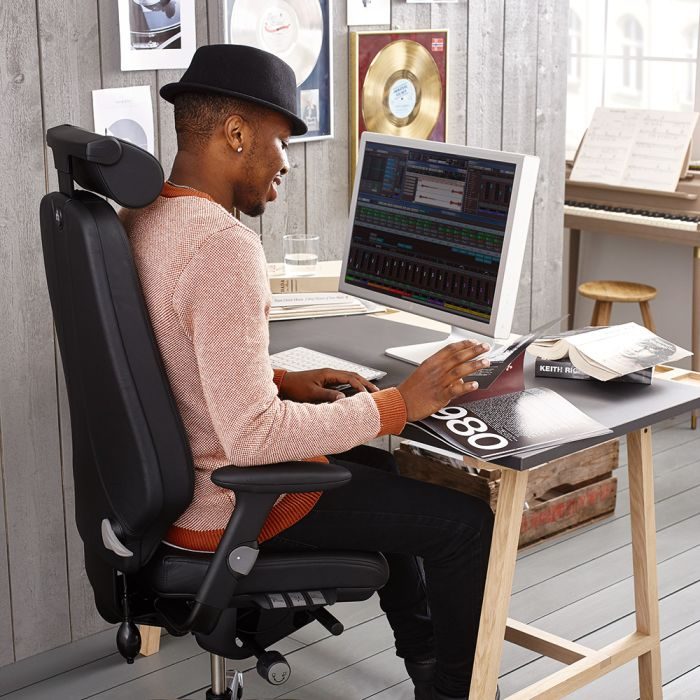 Image of a man sitting comfortably at a desk