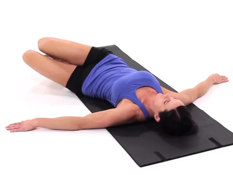 Image of a woman performing the supine lower trunk rotation exercise