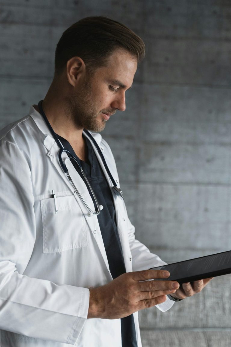 Image of a male medical professional looking a some medical notes