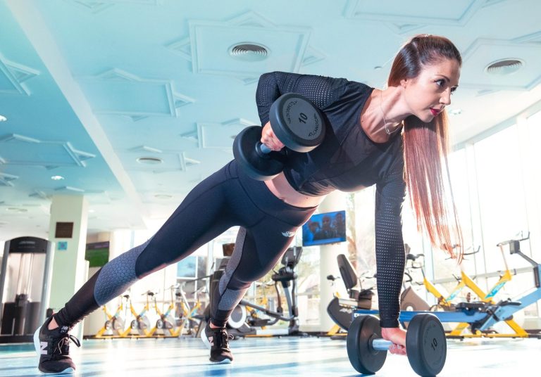 Image of a woman working out with two dumbells